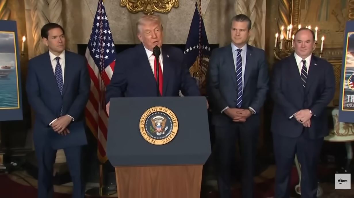 Donald Trump pointing during a press conference regarding the Iran ultimatum and potential geopolitical conflict.